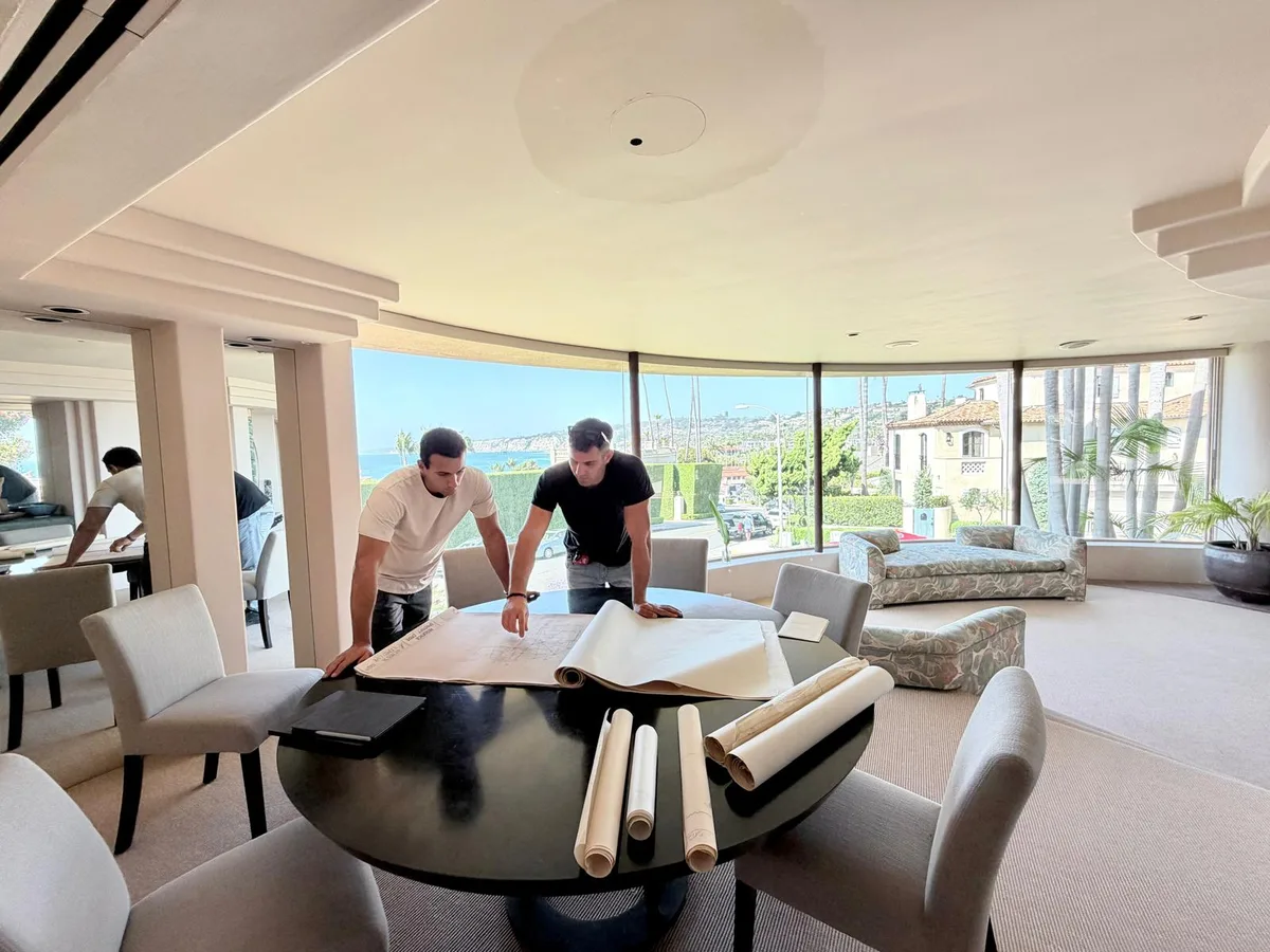 Troia Construction team reviewing project plans in an oceanfront La Jolla home