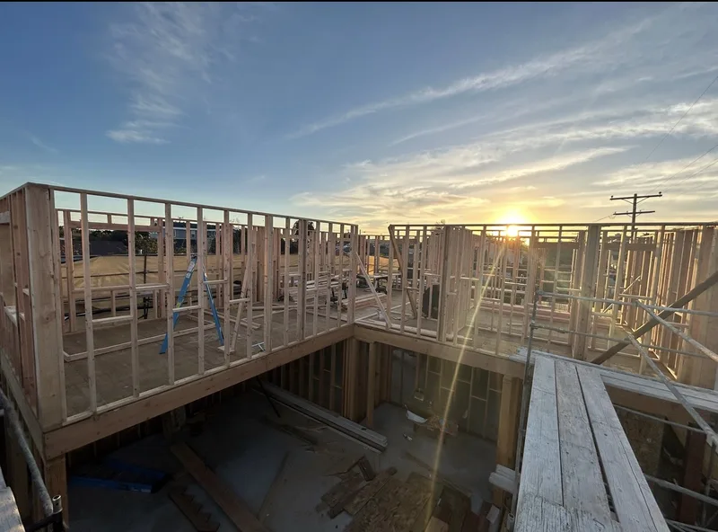 Framing at sunset showing second-story construction