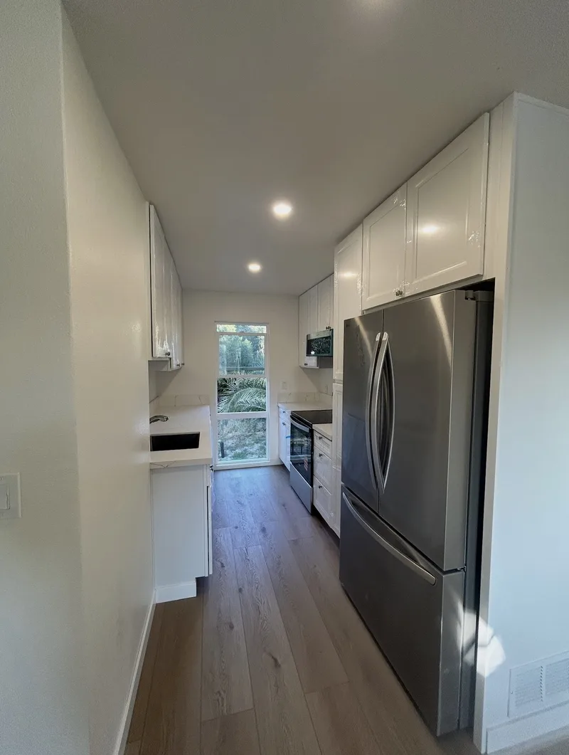 Finished galley kitchen with stainless steel appliances