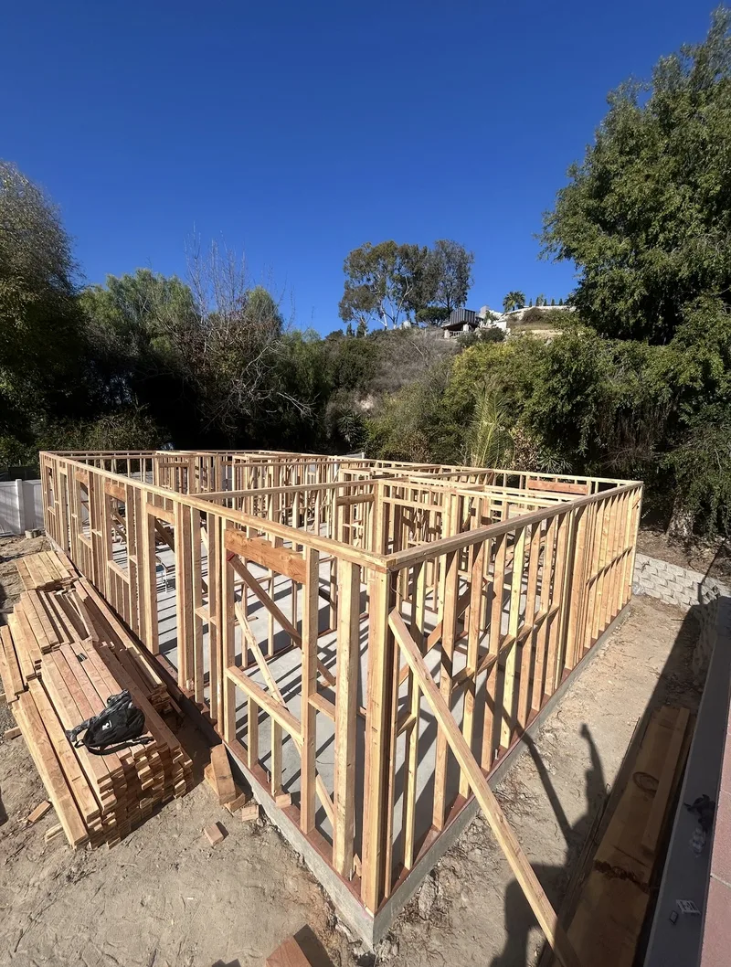 Ground-level wall framing for new construction on a hillside lot